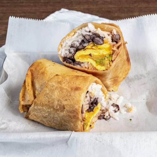 Two halves of a Healthy Habit breakfast burrito, filled with rice, black beans, and scrambled eggs.